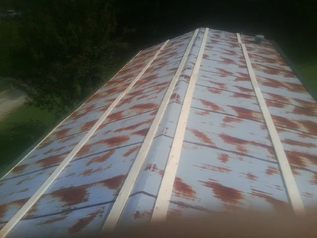 Rusted metal roof panels with new wood purlins before replacement — Storm Damage Roof Repair in Deary by Roofing Brothers
